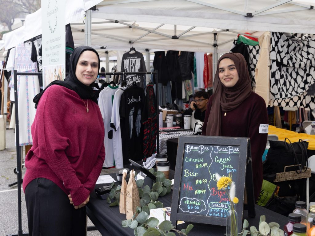 Two women selling goods at the Global Muslim Village