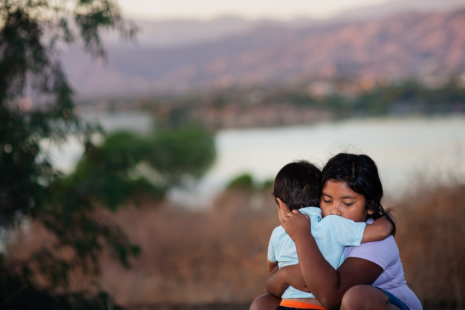 Two children holding each other